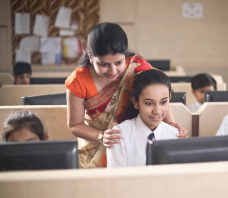 Secondary school teacher guiding student